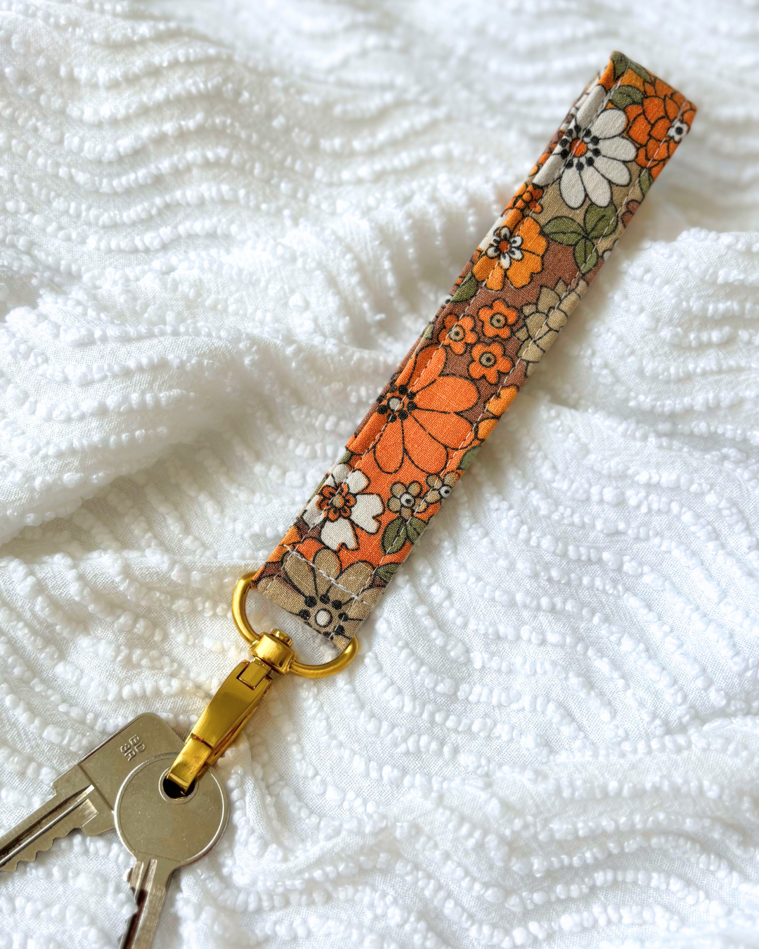 Porte-clés flower power orange